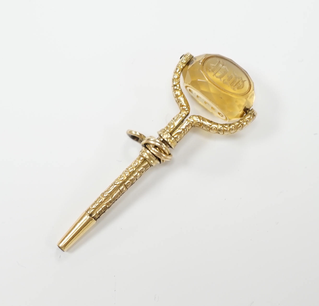 A Victorian yellow metal overlaid and swivelling citrine set watch key, 49mm.